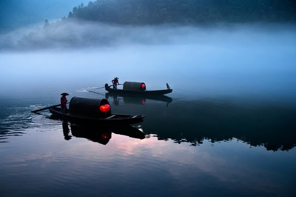 Переправа по реке рано утром в Китае.