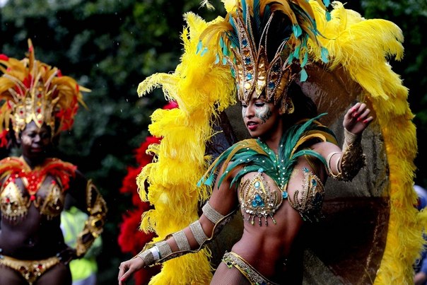 Девушки танцуют во время Ноттинг-Хиллского карнавала в Лондоне, Англия. Это самый большой карнавал Европы. Впервые был проведен афро-карибскими общинами Великобритании в 1964 году. 