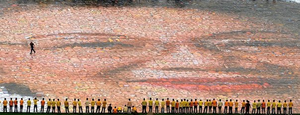 Студенты колледжа стоят у самой большой фото-мозаики бывшего президента Филиппин Корасон Акино в Маниле. Мозаика состоит из 3200 фотографий и весит почти 4 тонны.