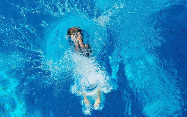 Мальчик прыгает в бассейн в Ганновере, Германия, 17 июня 2013 года.